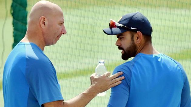 Indian cricket team captain Virat Kolhi with team's physiotherapist Patrick Farhart during the practice session in Dharamsala. (PTI) Indian cricket team captain Virat Kolhi with team's physiotherapist Patrick Farhart during the practice session in Dharamsala. (PTI)