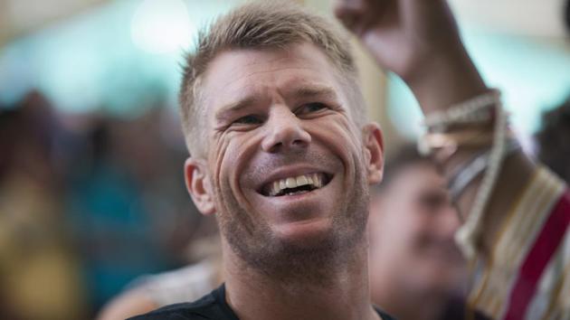 Australian cricketer David Warner laughs as he talks to a fan during an interaction with the Tibetan spiritual leader Dalai Lama. (AP) 