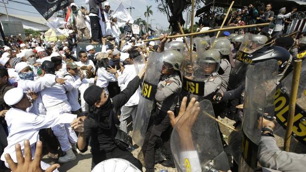 Police officers clash with Muslim hardliners during a protest against the construction of a Catholic church in Bekasi, Indonesia. (AP Photo) Police officers clash with Muslim hardliners during a protest against the construction of a Catholic church in Bekasi, Indonesia. (AP Photo)