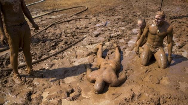 At the end, men and women caked in mud collapsed in the late morning sun. (Oded Balilty/AP)
