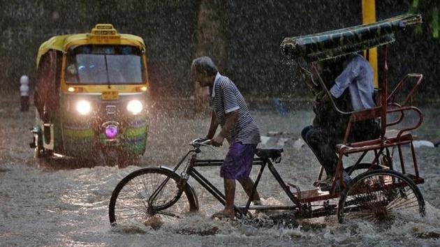 A man pedals his cycle rickshaw during monsoon rains in New Delhi. (Reuters photo) A man pedals his cycle rickshaw during monsoon rains in New Delhi. (Reuters photo)