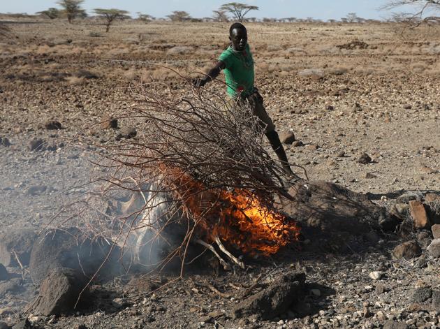 REFILE - FIXING DATE CORRECTED IN ERROR. A Turkana tribesman burns goats carcasses in a village near Loiyangalani. (Goran Tomasevic / Reuters) REFILE - FIXING DATE CORRECTED IN ERROR. A Turkana tribesman burns goats carcasses in a village near Loiyangalani. (Goran Tomasevic / Reuters)