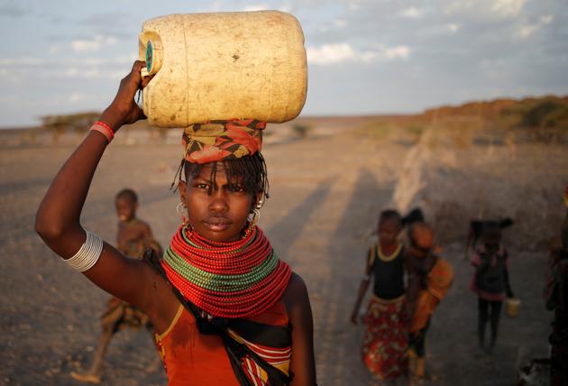 A woman carries a water canister in a village near Loiyangalani. (Goran Tomasevic / Reuters) A woman carries a water canister in a village near Loiyangalani. (Goran Tomasevic / Reuters)