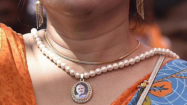 A BJP supporter wearind pendent bearing PM Modi’s photo during Panch Parmeshwaar Booth Sammelan at Ramlila Ground in New Delhi. (Vipin Kumar/HT PHOTO) A BJP supporter wearind pendent bearing PM Modi’s photo during Panch Parmeshwaar Booth Sammelan at Ramlila Ground in New Delhi. (Vipin Kumar/HT PHOTO)