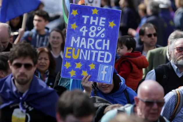 Demonstrators hold placards and wave EU flags as they participate in an anti Brexit, pro-EU march in London. (AFP) Demonstrators hold placards and wave EU flags as they participate in an anti Brexit, pro-EU march in London. (AFP)