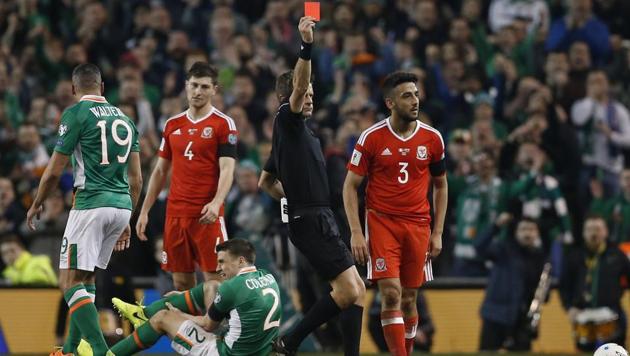 Wales' Neil Taylor is sent off by referee Nicola Rizzoli as Republic of Ireland's Seamus Coleman lies injured.(REUTERS)