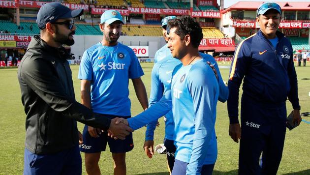 Kuldeep Yadav being congratulated by Virat Kohli after getting his Test cap ahead of the fourth India vs Australia Test in Dharamsala.(BCCI)