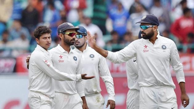 Kuldeep Yadav (left) celebrates after taking a wicket during the India vs Australia fourth Test in Dharamsala. Get live cricket score of India vs Australia Dharamsala Test here.(PTI)
