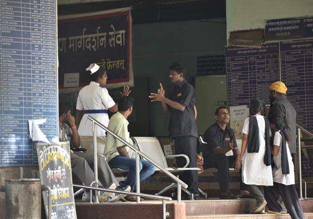 Patients wait outside Sion Hospital on Friday. (Arijit Sen/HT Photo)
