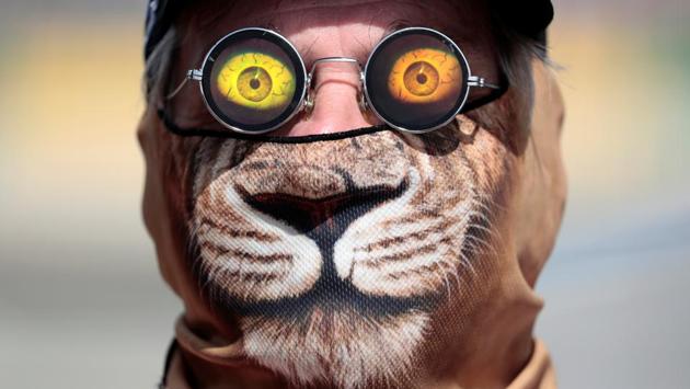 Formula One - F1 - Australian Grand Prix - Melbourne, Australia - 24/03/2017 Race official Graham Warren wears a cat mask and 3D sunglasses trackside during the first Formula One practice session. (Jason Reed  / REUTERS) 