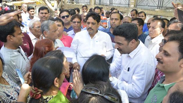 MLA Sunil Sharma (centre) with Indirapuram residents and GDA officials at the 'sewer panchayat' on Saturday. (Sakib Ali/HT Photo) MLA Sunil Sharma (centre) with Indirapuram residents and GDA officials at the 'sewer panchayat' on Saturday. (Sakib Ali/HT Photo)