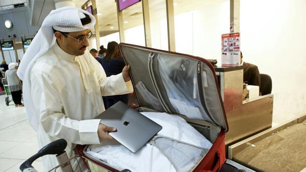 Kuwaiti social media activist Thamer al-Dakheel Bourashed puts his laptop inside his suitcase at Kuwait International Airport in Kuwait City before boarding a flight to the United States on March 23, 2017. (AFP Photo) Kuwaiti social media activist Thamer al-Dakheel Bourashed puts his laptop inside his suitcase at Kuwait International Airport in Kuwait City before boarding a flight to the United States on March 23, 2017. (AFP Photo)