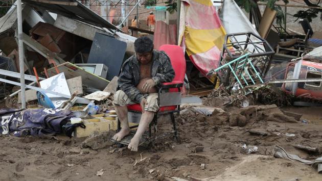 A resident sits outside his home after a massive landslide and flood in Viru, Trujillo, northern Peru, March 20, 2017.  (Douglas Juarez  / REUTERS) 