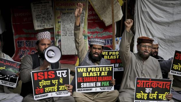 Muslims hold placards in New Delhi as they shout slogans to condemn Thursday's suicide bombing at the Lal Shahbaz Qalandar shrine in southern Pakistan. (PTI) Muslims hold placards in New Delhi as they shout slogans to condemn Thursday's suicide bombing at the Lal Shahbaz Qalandar shrine in southern Pakistan. (PTI)