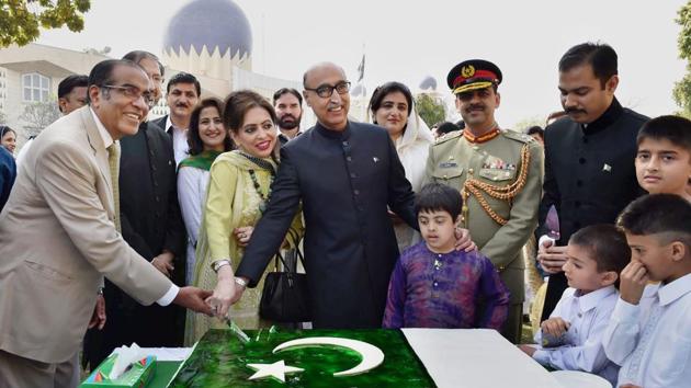 Pakistan high commissioner Abdul Basit (in black) cuts the cake during the Pakistan Day celebrations in New Delhi on Thursday. (PTI Photo) Pakistan high commissioner Abdul Basit (in black) cuts the cake during the Pakistan Day celebrations in New Delhi on Thursday. (PTI Photo)