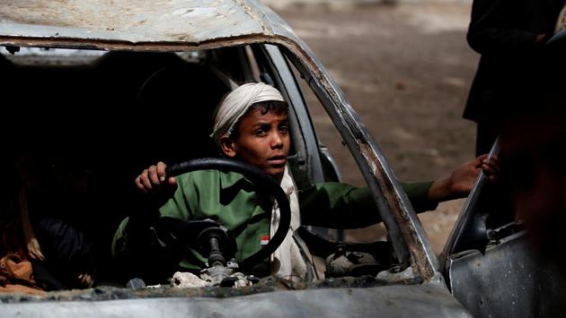 Boys play in an abandoned car in the yard of The al-Shawkani Foundation for Orphans Care in Sanaa, Yemen. (Khaled Abdullah / REUTERS) 