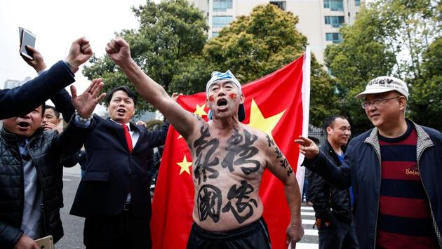 Supporters of the Chinese national team chant slogans outside Helong Stadium ahead of a 2018 FIFA World Cup qualifier match between China and South Korea in Changsha, Hunan province, China, March 23, 2017. (REUTERS) 