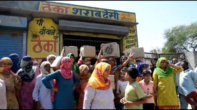 Women outside a liquor vend at Gamri village in Sonepat. (HT Photo) Women outside a liquor vend at Gamri village in Sonepat. (HT Photo)