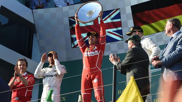 Ferrari's Sebastian Vettel (C) lifts the trophy after winning with runner-up Mercedes's Lewis Hamilton (2nd L) and third-placed Mercedes' Valtteri Bottas (2nd R) during the podium ceremony of the Formula One Australian Grand Prix at Albert Park in Melbourne on Sunday. (AFP) Ferrari's Sebastian Vettel (C) lifts the trophy after winning with runner-up Mercedes's Lewis Hamilton (2nd L) and third-placed Mercedes' Valtteri Bottas (2nd R) during the podium ceremony of the Formula One Australian Grand Prix at Albert Park in Melbourne on Sunday. (AFP)