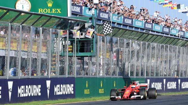 Ferrari's Sebastian Vettel takes the chequered flag at the Formula One Australian Grand Prix at Albert Park in Melbourne on Sunday. (AFP) Ferrari's Sebastian Vettel takes the chequered flag at the Formula One Australian Grand Prix at Albert Park in Melbourne on Sunday. (AFP)
