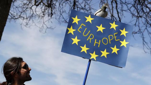 A man looks up at a model of a pigeon on top of a banner as anti Brexit campaigners gather at Hyde Park Corner in London. (Kristy Wigglesworth/AP) A man looks up at a model of a pigeon on top of a banner as anti Brexit campaigners gather at Hyde Park Corner in London. (Kristy Wigglesworth/AP)