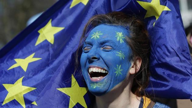 A demonstrator with her face painted in the colours of the EU flag participates in the march. (AFP) A demonstrator with her face painted in the colours of the EU flag participates in the march. (AFP)