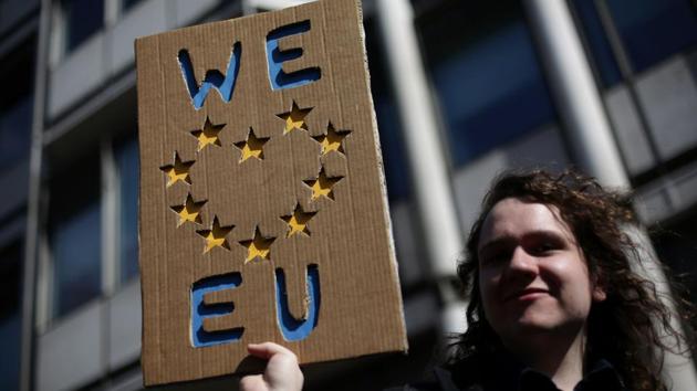A demonstrator holds a placard that reads "We Love EU" as he prepares to participate in an anti Brexit, pro-European Union (EU) march in London. Tens of thousands protested Saturday under sunny skies in London against plans for Britain to withdraw from the European Union. (Daniel Leal-Olivas/AFP) A demonstrator holds a placard that reads "We Love EU" as he prepares to participate in an anti Brexit, pro-European Union (EU) march in London. Tens of thousands protested Saturday under sunny skies in London against plans for Britain to withdraw from the European Union. (Daniel Leal-Olivas/AFP)