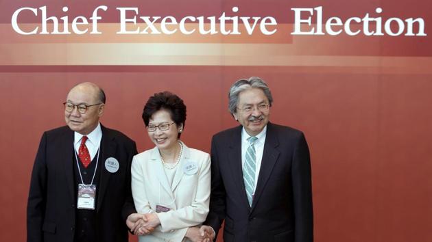 Candidates (left to right) Woo Kwok-hing, Carrie Lam and John Tsang greet committee members during elections for Hong Kong's next chief executive in China on Sunday. (Reuters Photo) Candidates (left to right) Woo Kwok-hing, Carrie Lam and John Tsang greet committee members during elections for Hong Kong's next chief executive in China on Sunday. (Reuters Photo)