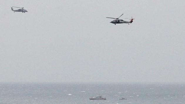 A Iranian Revolutionary Guard boat is seen near the U. aircraft carrier, USS George H. W. Bush while transiting Straits of Hormuz as U.S. Navy helicopters hover over it during early hours of March 21, 2017. (REUTERS) A Iranian Revolutionary Guard boat is seen near the U. aircraft carrier, USS George H. W. Bush while transiting Straits of Hormuz as U.S. Navy helicopters hover over it during early hours of March 21, 2017. (REUTERS)