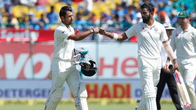 Cheteshwar Pujara and KL Rahul walk back after the first session during day two of the fourth test match between India and Australia in Dharamsala.(BCCI)