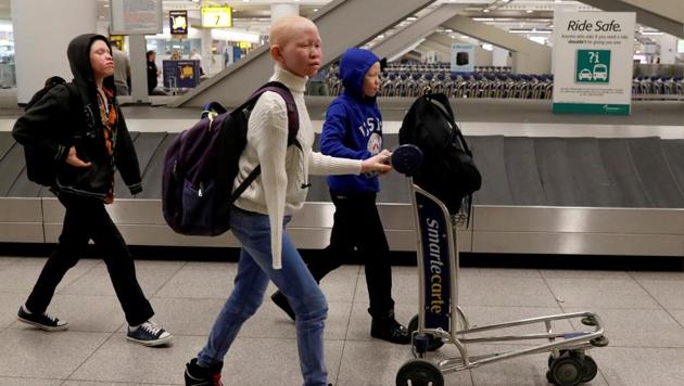 Emmanuel Rutema, Pendo Noni, and Mwigulu Magesa (L to R), Tanzanians with Albinism visiting the U.S. for medical care, walk through JFK International Airport after arriving in New York City, U.S. Four Tanzanian children with albinism, who lost limbs in brutal superstition-driven attacks, arrived in the United States on Saturday for medical treatment and respite from a homeland where they are persecuted and feared. (Brendan McDermid/REUTERS) Emmanuel Rutema, Pendo Noni, and Mwigulu Magesa (L to R), Tanzanians with Albinism visiting the U.S. for medical care, walk through JFK International Airport after arriving in New York City, U.S. Four Tanzanian children with albinism, who lost limbs in brutal superstition-driven attacks, arrived in the United States on Saturday for medical treatment and respite from a homeland where they are persecuted and feared. (Brendan McDermid/REUTERS)