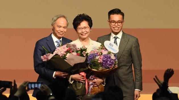 Carrie Lam (centre) holds bouquets as she stands on stage after winning the Hong Kong chief executive election on Sunday. (AFP) Carrie Lam (centre) holds bouquets as she stands on stage after winning the Hong Kong chief executive election on Sunday. (AFP)