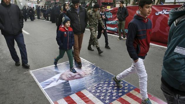 Iranians march on a portrait of US President Donald Trump and the picture of US flag in an annual rally commemorating the anniversary of the 1979 Islamic revolution which toppled the late pro-US Shah, Mohammad Reza Pahlavi, in Tehran on Feb 10. (AP File Photo) Iranians march on a portrait of US President Donald Trump and the picture of US flag in an annual rally commemorating the anniversary of the 1979 Islamic revolution which toppled the late pro-US Shah, Mohammad Reza Pahlavi, in Tehran on Feb 10. (AP File Photo)