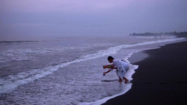 A Balinese Hindu woman collects sea water on a beach during Melasti, a purification ceremony ahead of the holy day of Nyepi, in Gianyar, Bali, Indonesia. (Agung Parameswara/REUTERS) A Balinese Hindu woman collects sea water on a beach during Melasti, a purification ceremony ahead of the holy day of Nyepi, in Gianyar, Bali, Indonesia. (Agung Parameswara/REUTERS)