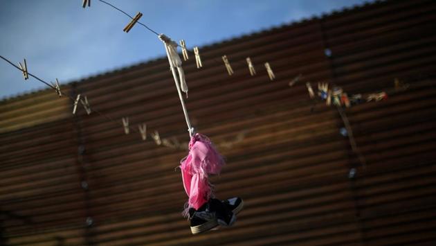 A shoe and clothes pins are seen on a clothes line next to a section of the border fence separating Mexico and the United States, on the outskirts of Tijuana, Mexico. (Edgard Garrido/REUTERS) A shoe and clothes pins are seen on a clothes line next to a section of the border fence separating Mexico and the United States, on the outskirts of Tijuana, Mexico. (Edgard Garrido/REUTERS)