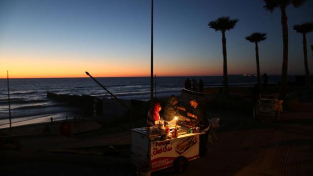 A man sells hot dogs next to the fence separating Mexico and the United States, in Tijuana, Mexico. (Edgard Garrido/REUTERS) A man sells hot dogs next to the fence separating Mexico and the United States, in Tijuana, Mexico. (Edgard Garrido/REUTERS)