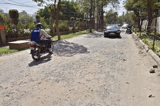 A broken road in Sushant Lok I, Gurgaon. (Sanjeev Verma/HT Photot) A broken road in Sushant Lok I, Gurgaon. (Sanjeev Verma/HT Photot)
