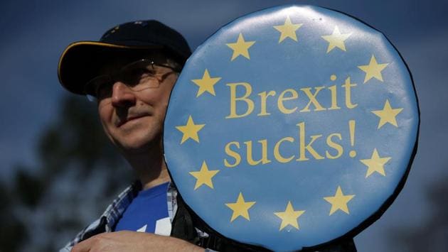 A demonstrator holds a placard reading "Brexit Sucks!" during the march. The crowds observed a minute of silence at Parliament Square as a tribute to the four victims killed and dozens wounded in an attack Wednesday on Parliament. (Daniel Leal-Olivas/AFP) A demonstrator holds a placard reading "Brexit Sucks!" during the march. The crowds observed a minute of silence at Parliament Square as a tribute to the four victims killed and dozens wounded in an attack Wednesday on Parliament. (Daniel Leal-Olivas/AFP)