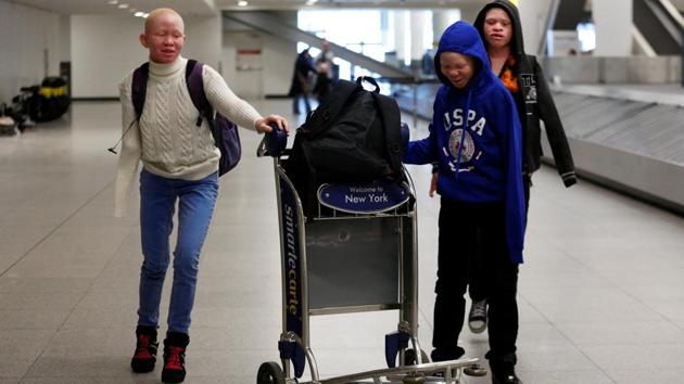 Pendo Noni, Mwigulu Magesa and Emmanuel Rutema, (L-R) Tanzanian's with Albinism visiting the U.S. for medical care, walk through JFK International Airport after arriving in New York City. The oldest boy, 15-year-old Emmanuel Rutema, speaks with difficulty. His attackers chopped off one arm and the fingers of the other and tried to pull out his tongue and teeth. (Brendan McDermid/REUTERS) Pendo Noni, Mwigulu Magesa and Emmanuel Rutema, (L-R) Tanzanian's with Albinism visiting the U.S. for medical care, walk through JFK International Airport after arriving in New York City. The oldest boy, 15-year-old Emmanuel Rutema, speaks with difficulty. His attackers chopped off one arm and the fingers of the other and tried to pull out his tongue and teeth. (Brendan McDermid/REUTERS)