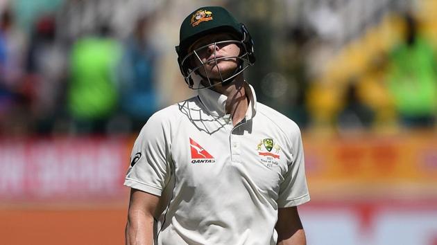Australia's captain Steve Smith reacts as he walks back to the pavilion after his dismissal by India's Bhuvneshwar Kumar during the third day of the fourth and last Test cricket match between India and Australia in Dharamsala.(AFP)