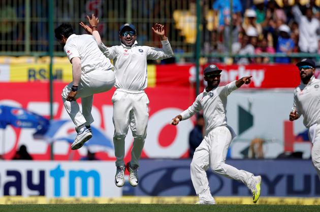 Umesh Yadav (left) celebrates with Karun Nair and Ajinkya Rahane (right) after dismissing Matt Renshaw on Day 3 of the fourth Test in Dharamsala on Monday. The Indian cricket team is 87 runs away from a famous series win against the Australian cricket team.(REUTERS)