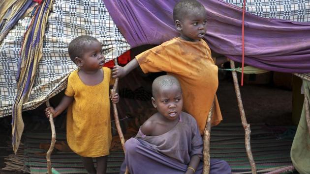 Newly displaced Somali children stand outside their makeshift shelter at a camp in Baidoa, Somalia. Many of them are clueless about what to do next. (Farah Abdi Warsameh/AP)