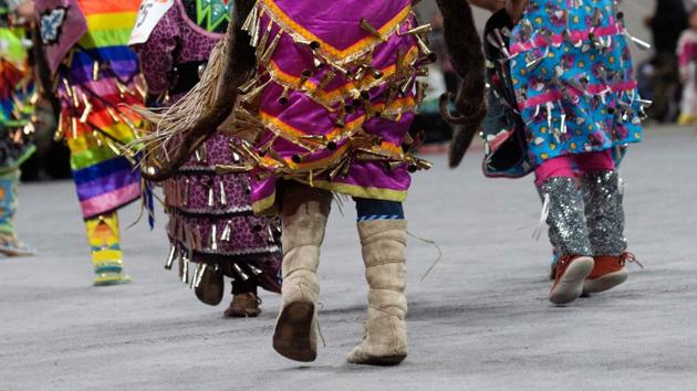 The beating drums and song filled the Denver Coliseum , as hundreds entered dancing, wrapping around the floor and circling the color guard and veterans.. (Jason Connolly / AFP)