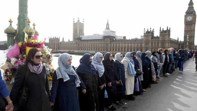 A group of Muslim women formed a human chain along the iconic Westminster Bridge here in a show of solidarity with the victims of deadly terror attack outside the British Parliament that killed four people.(Reuters Photo)
