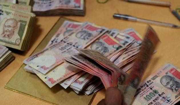 Anil Jain had collected the banned notes in denomination of Rs1,000 and Rs500 from various businessmen after promising them to get the notes exchanged with valid banknotes on 50% commission basis.(AFP File)