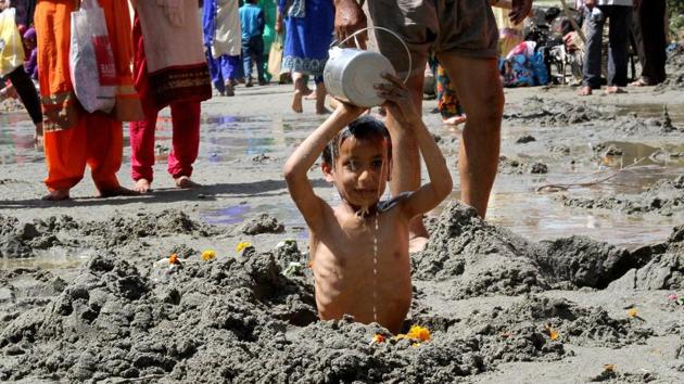 A child devotee offering prayer during the three-day Chadhi Yatra ahead of Navratra festival, at Parmandal, about 25 km from Jammu. (PTI)