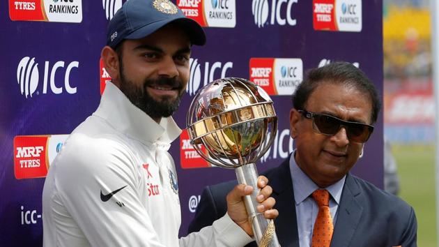 Virat Kohli receives the ICC Test Championship Mace from Sunil Gavaskar after their series win over Australia.(REUTERS)
