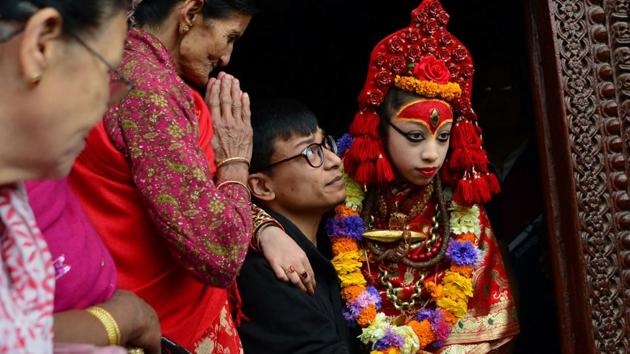 A Nepalese priest carries the Living Goddess, the Kumari, during the Ghode Jatra (Horse Race) Festival in Kathmandu. The Kumari is worshipped by both Hindus and Buddhists as a living goddess and a protector bringing good luck and prosperity.  (Prakash Mathema/AFP) 