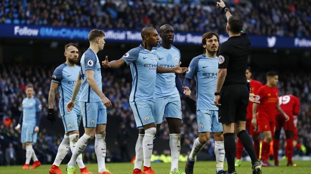 Referee Michael Oliver speaks to Manchester City's David Silva (R) and team mates after awarding Liverpool a penalty during their Premier League clash on March 20.(REUTERS)