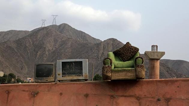 Televisions and a chair sit on a pedestrian bridge after rivers breached their banks due to torrential rains, causing flooding and widespread destruction in Carapongo Huachipa, Lima, Peru. On the outskirts of Lima, hundreds of householders salvage scant belongings in what is left of their homes after the Rimac River burst its banks in recent weeks amid Peru’s worst flooding disaster in decades. (Mariana Bazo/REUTERS)